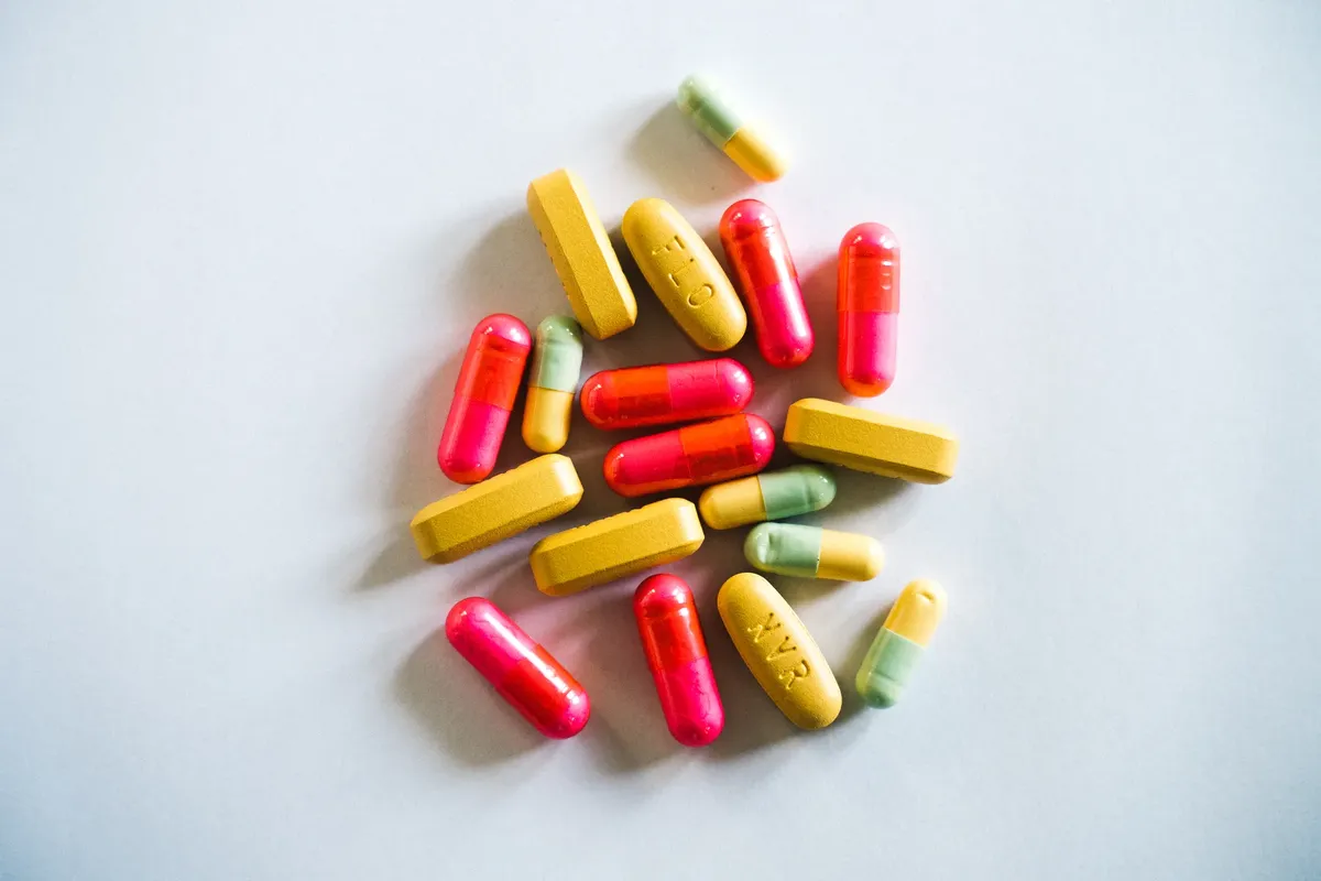 A vibrant assortment of various pills and capsules on a light background, showcasing pharmaceutical diversity.