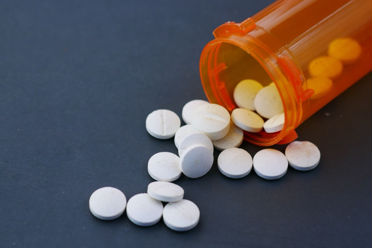 Pharmaceutical tablet and pill bottle in white background