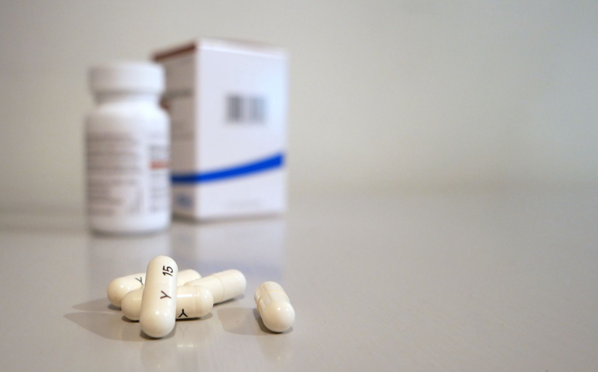 Un'etichetta farmaceutica in italiano con istruzioni di sicurezza. Il testo è dettagliato e chiaro, con un bordo metallico scuro. Il fondo è bianco e pulito.